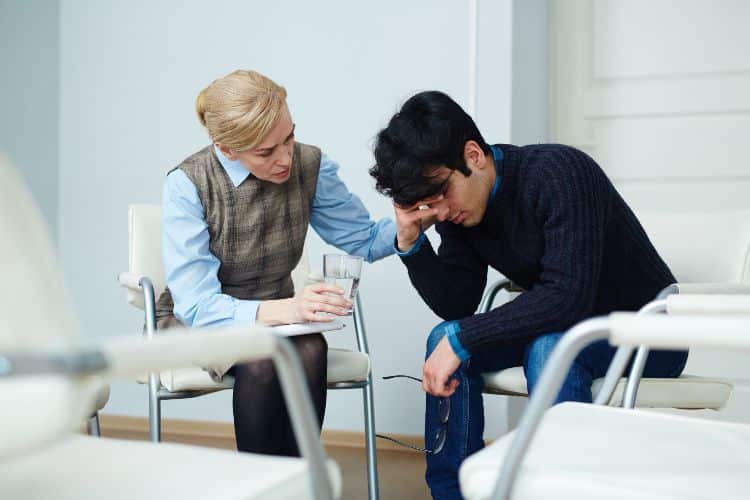 Frustrated young man visiting psychologist