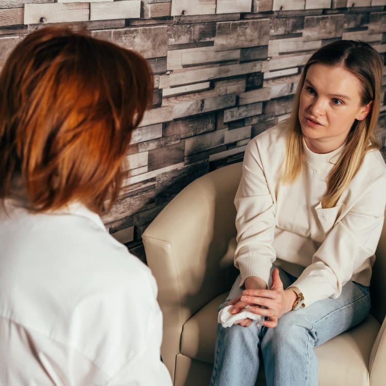 Woman psychologist talking to patient.