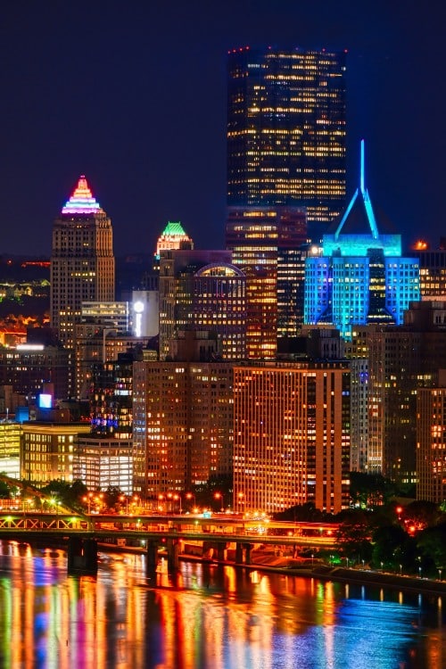 Vertical shot of the skyline of Pittsburgh in PA with lights at night