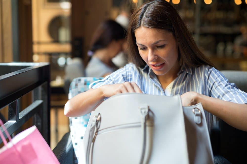 woman in coffee shop with shopping bags