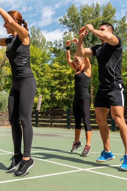 Cardio training with a group on an outdoor basketball court