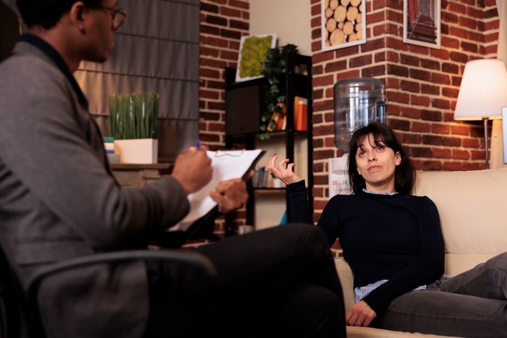 Stressed person with psychological issues attending therapy session