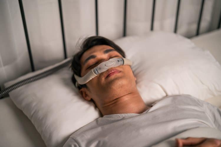 Asian man wearing cpap machine
