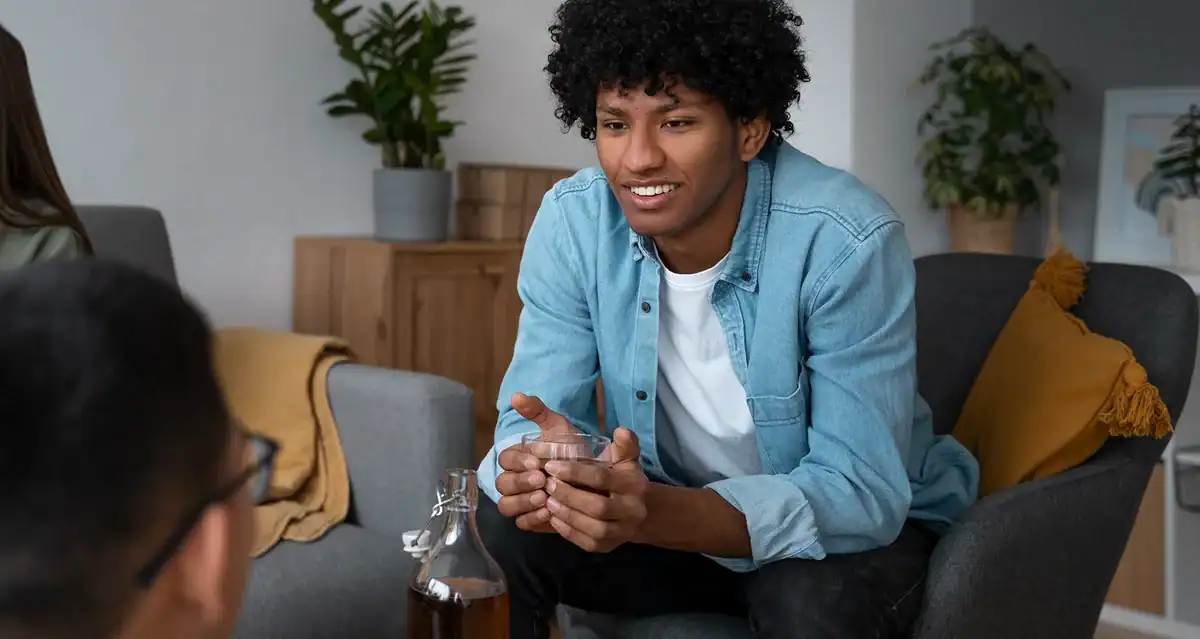 Young man smiling during therapy session at Healthy Life Recovery.