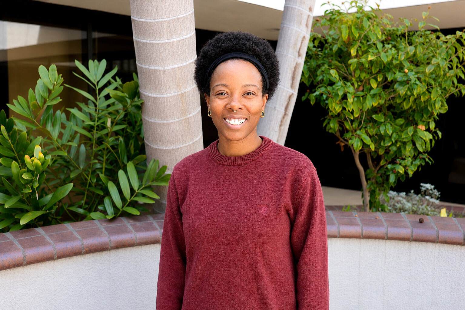 Smiling woman staff member at Healthy Life Recovery facility.