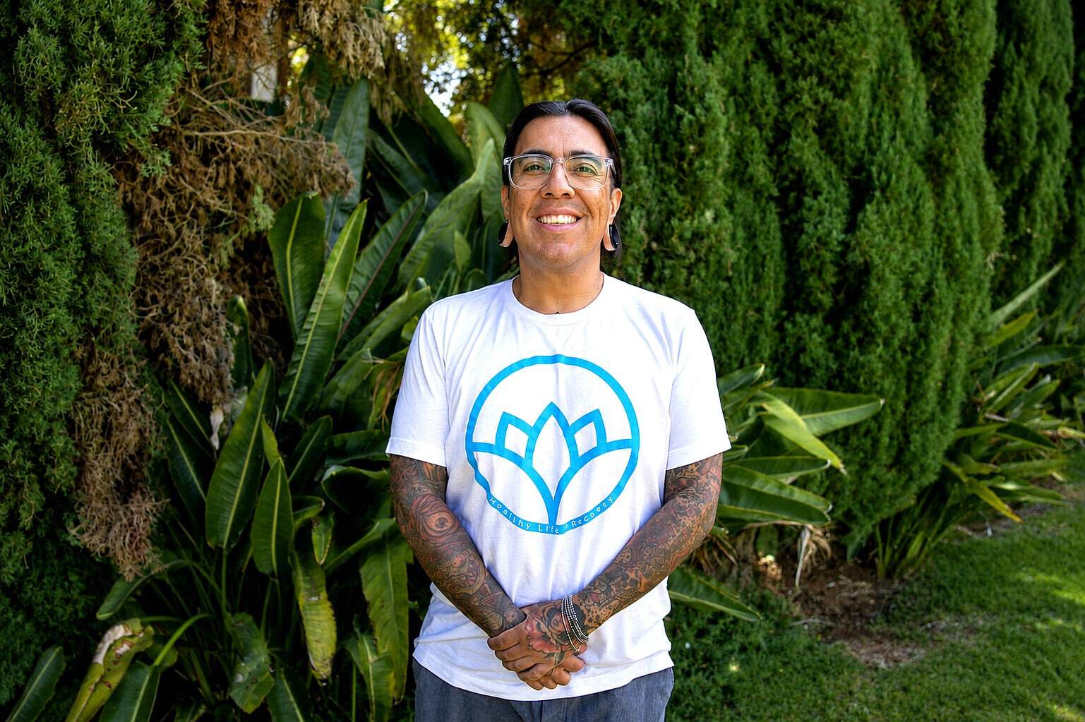 Smiling staff member from Our Staff at Healthy Life Recovery outdoors.