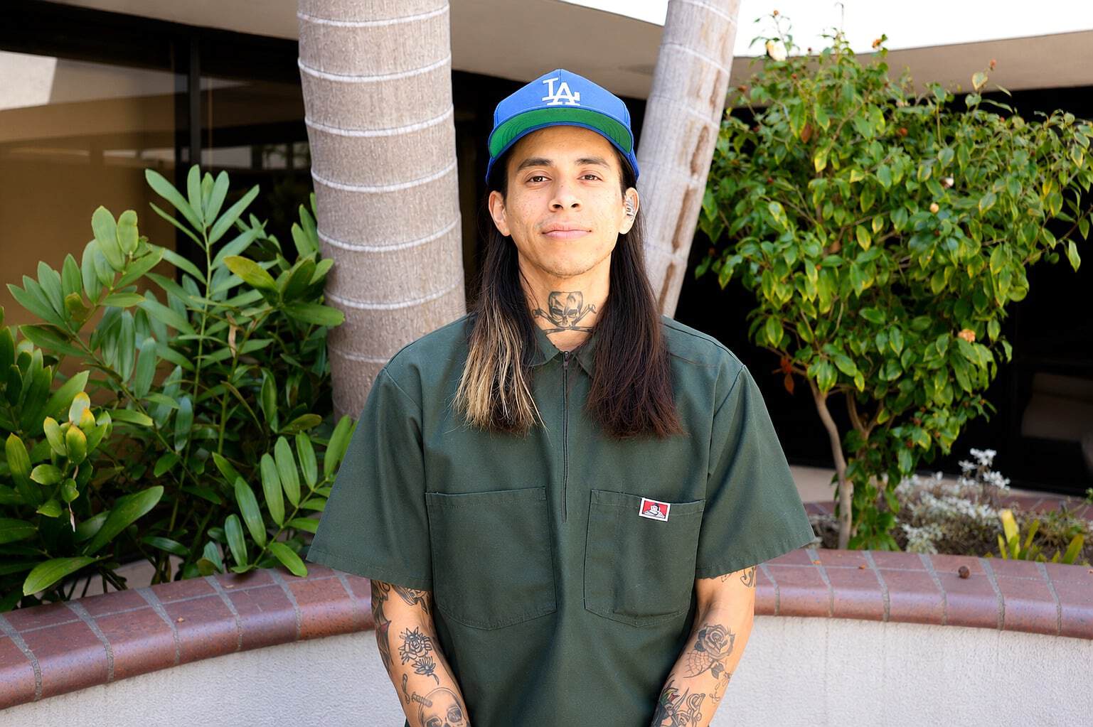 Staff member at Healthy Life Recovery with tattoos and casual attire.